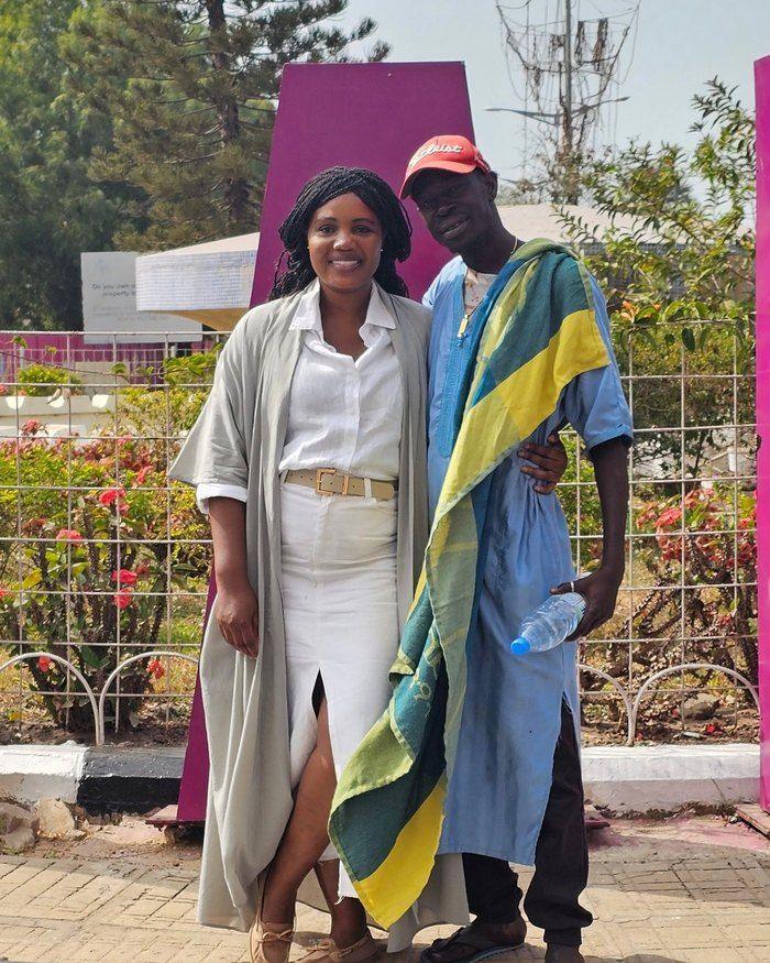 Kadine Reynolds with a man in a blue robe and red cap, Banjul, The Gambia