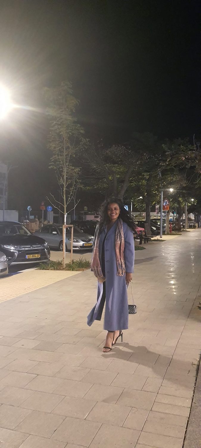 Kadine Reynolds walking at night in Tel Aviv, Israel