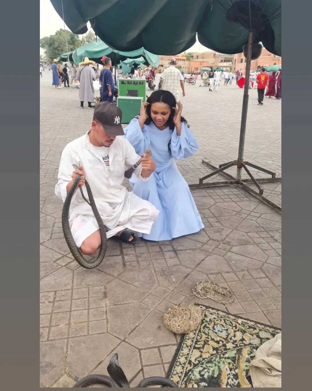 Kadine Reynolds with a snake charmer in Jemaa el-Fnaa, Marrakech, Morocco